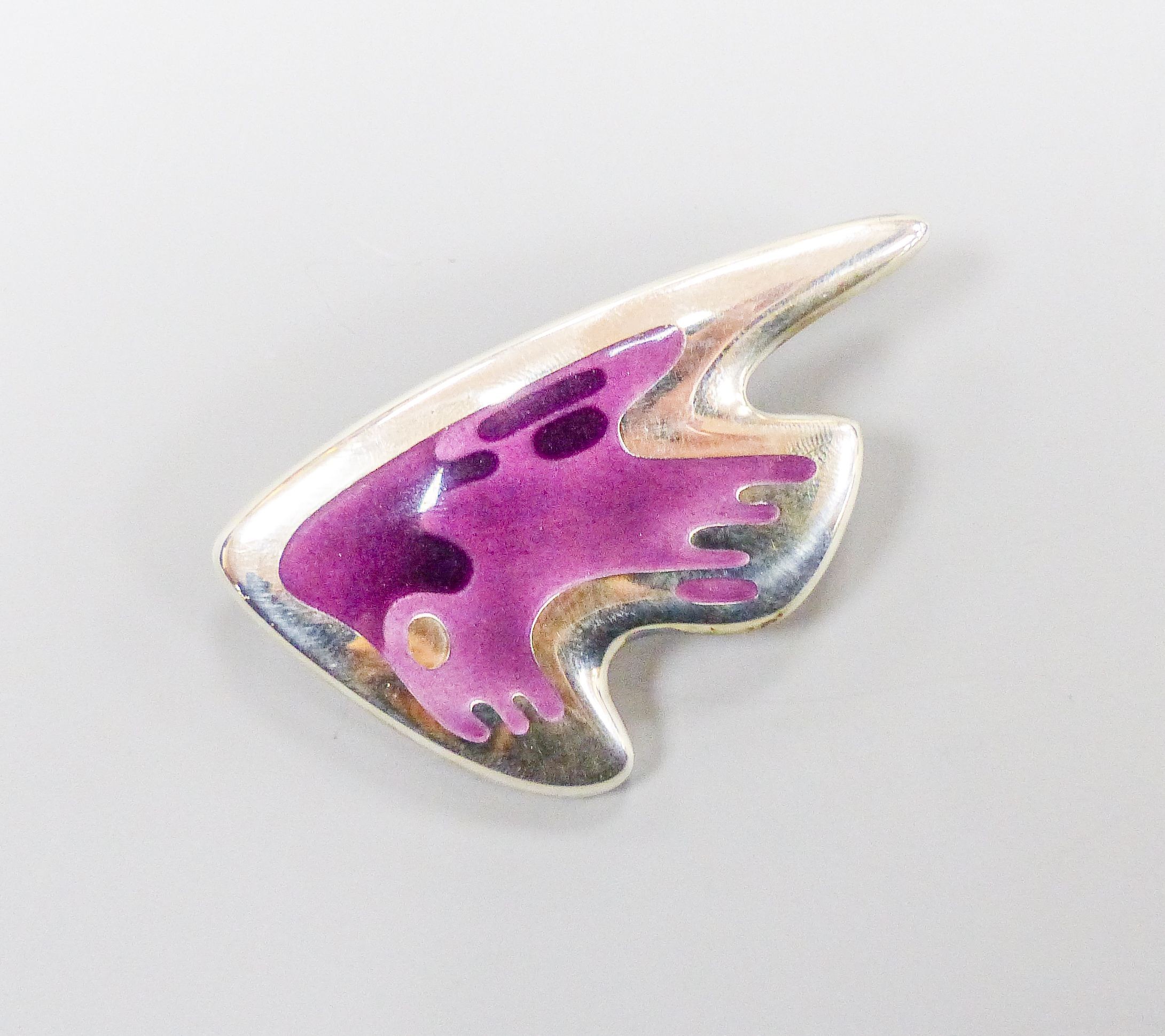 A Henning Koppel for Georg Jensen sterling and two colour mauve enamel stylised fish brooch, no. 307, 61mm.